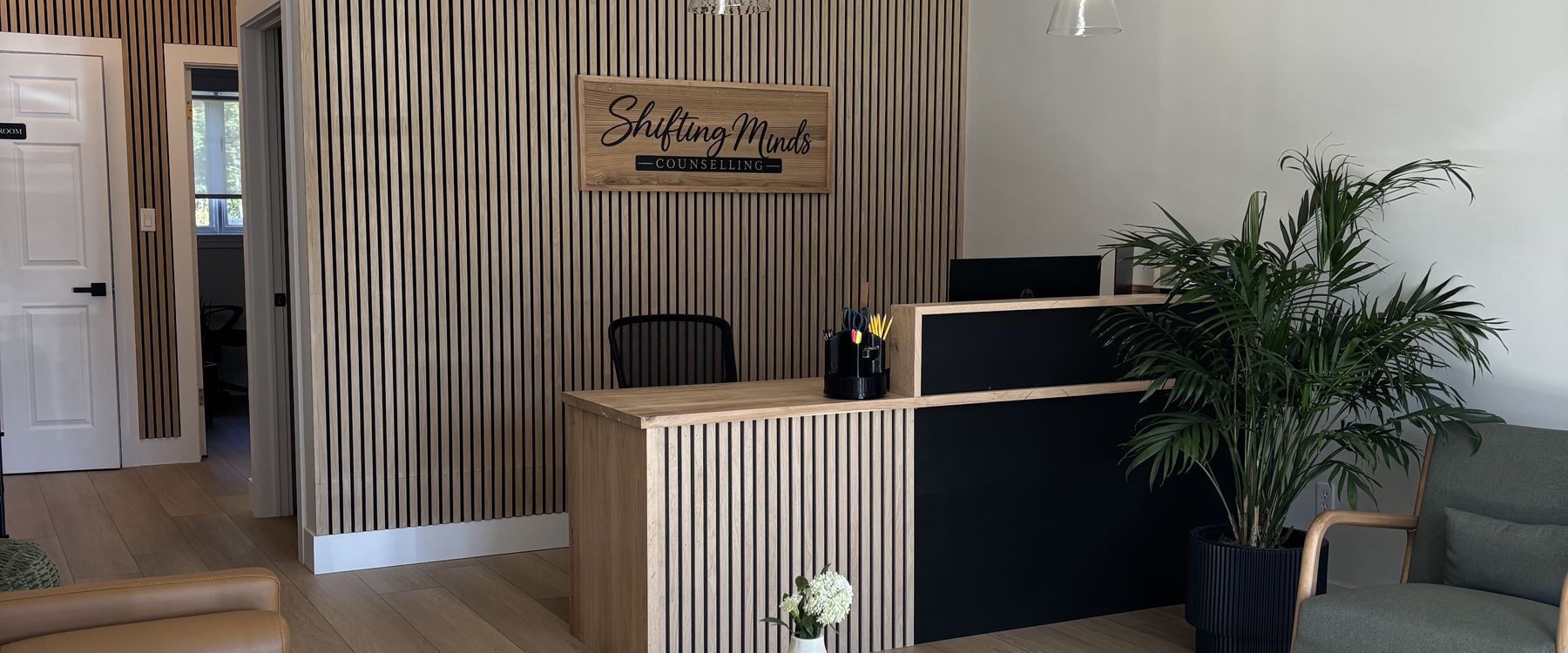 The Shifting Minds waiting room, with the sign behind the reception desk